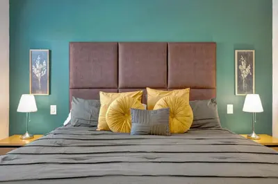 a bedroom with a large bed with yellow pillows at Cozy townhouse in Encantada resort- 5 miles from Disney in Kissimmee
