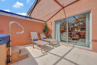 a patio with two chairs and a table and a window at Cozy townhouse in Encantada resort- 5 miles from Disney in Kissimmee