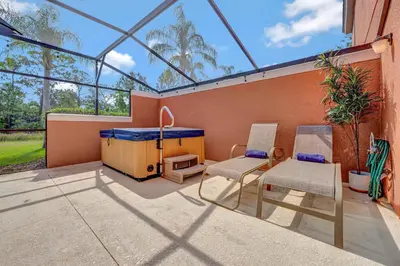 a patio with two chairs and a table and a stove at Cozy townhouse in Encantada resort- 5 miles from Disney in Kissimmee