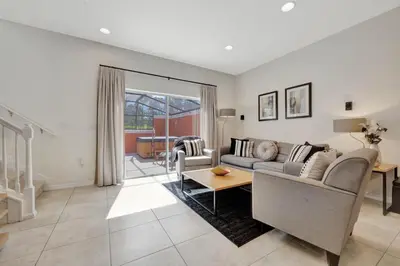 a living room with a couch and a table at Cozy townhouse in Encantada resort- 5 miles from Disney in Kissimmee