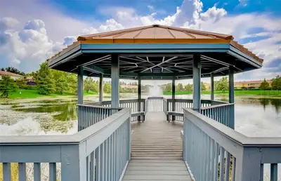 a gazebo on a bridge over a river at Cozy townhouse in Encantada resort- 5 miles from Disney in Kissimmee