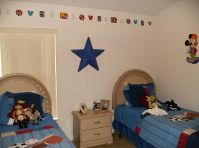 a bedroom with two beds and a star on the wall at Orlando Renters in Davenport