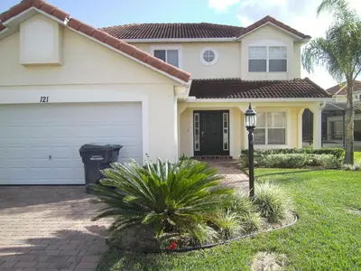 a house with a garage and a street light at Orlando Renters in Davenport