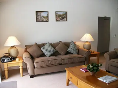 a living room with a brown couch and two lamps at Orlando Renters in Davenport