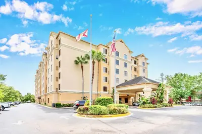 a hotel with a flag on top of it at Condo 1BR Near Disney- Pool and Hot Tub in Orlando