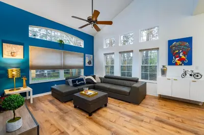 a living room with a couch and a ceiling fan at Natural Reserve Home at Emerald Islands in Kissimmee