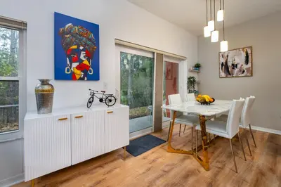 a dining room with a table and white chairs at Natural Reserve Home at Emerald Islands in Kissimmee