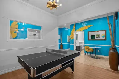 a ping pong table in a room with blue walls at Banana Leaf Villa-Vintage Vibes- King Suite in Orlando