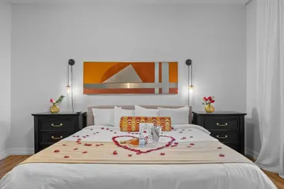 a bedroom with a large bed with flowers on it at Banana Leaf Villa-Vintage Vibes- King Suite in Orlando