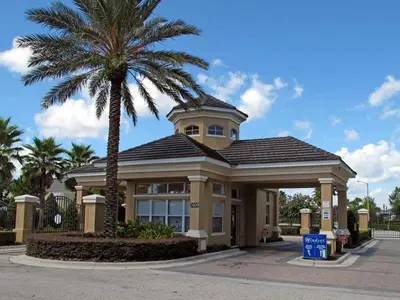 a building with a palm tree in front of it at 3 miles to Disney, water park, kids disney rooms, pool table, air hockey, private pool and spa in Orlando