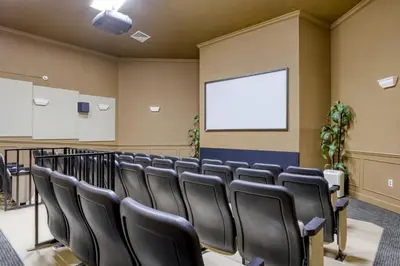 a conference room with black chairs and a screen at 3 miles to Disney, water park, kids disney rooms, pool table, air hockey, private pool and spa in Orlando