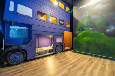 a bedroom with a bus mural on the wall at Amazing New 15-bed home up to 30 people in Orlando