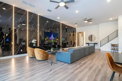 a living room with a couch and a tv at Amazing New 15-bed home up to 30 people in Orlando