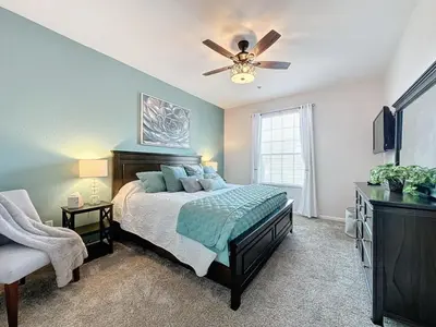 a bedroom with a bed and a ceiling fan at Summer Dreams 3 Bed Condo in Windsor Hills condo in Orlando