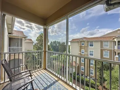 a balcony with a chair and a large window at Summer Dreams 3 Bed Condo in Windsor Hills condo in Orlando