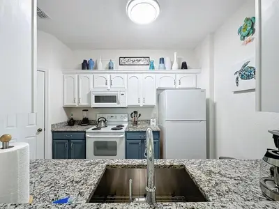 a kitchen with a sink and a white refrigerator at Summer Dreams 3 Bed Condo in Windsor Hills condo in Orlando