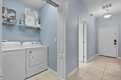 a laundry room with a washer and dryer at 8965 Cozy home Private Pool in Kissimmee