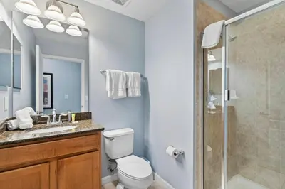 a bathroom with a toilet sink and a shower at 8965 Cozy home Private Pool in Kissimmee