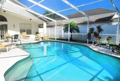 a large blue swimming pool in a house at Family Fun Vacation Home villa in Kissimmee