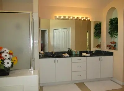 a bathroom with a sink and a large mirror at Family Fun Vacation Home villa in Kissimmee