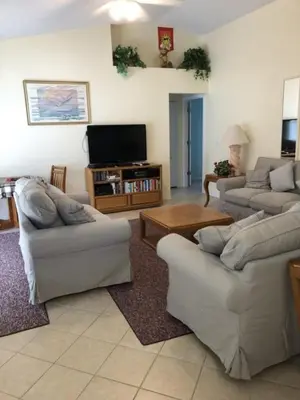 a living room with two couches and a tv at Family Fun Vacation Home villa in Kissimmee
