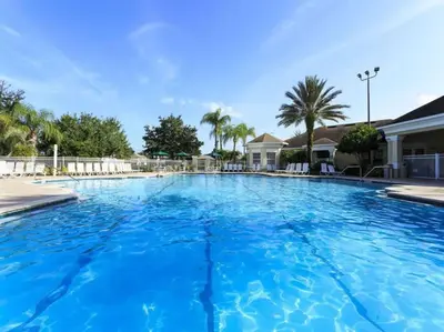 a large swimming pool with blue water at Disney Fan Condo-Renovated 2024 in Kissimmee
