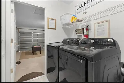 a laundry room with a washer and dryer in it at Tropical Escape By Shine Villas 244 in Kissimmee