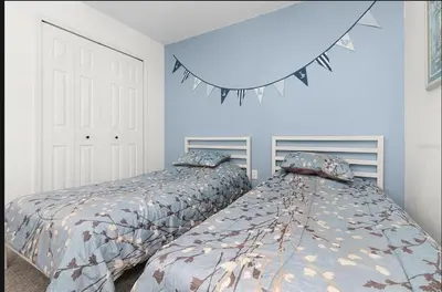 two beds sitting next to each other in a bedroom at Tropical Escape By Shine Villas 244 in Kissimmee