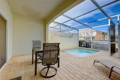 a home office with a desk and a swimming pool at Five Vacation Homes - Orlando in Orlando