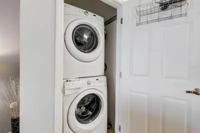 a laundry room with a washer and dryer next to a door at Five Vacation Homes - Orlando in Orlando
