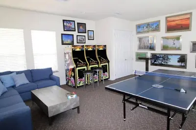 a living room with a ping pong table in it at Five Vacation Homes - Orlando in Orlando