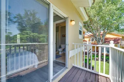 a balcony with a sliding glass door leading to a yard at 5 Mi to Disney Family-Friendly Kissimmee Retreat! in Kissimmee