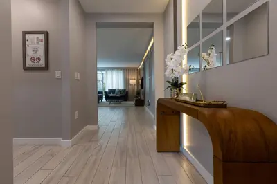 a living room with a wooden floor and a hallway at Beautiful Townhome with Splash Pool near Disney 31 in Kissimmee