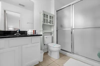 a white bathroom with a toilet and a shower at 3 Bed 2,5 Bath Perfect Family home Bunk Beds townhouse in Kissimmee