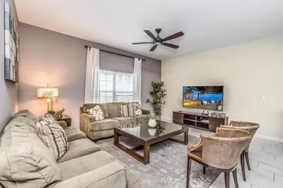 a living room with a couch and a tv at 3097Pequod townhouse in Kissimmee
