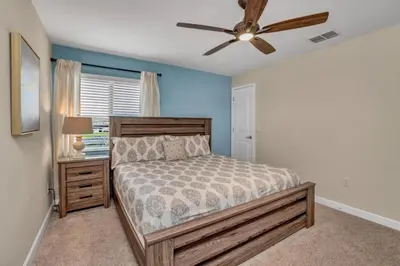 a bedroom with a bed and a ceiling fan at 3097Pequod townhouse in Kissimmee