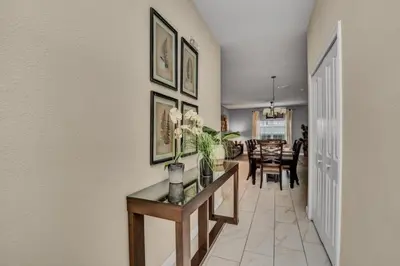 a hallway with a table and a dining room at 3097Pequod townhouse in Kissimmee
