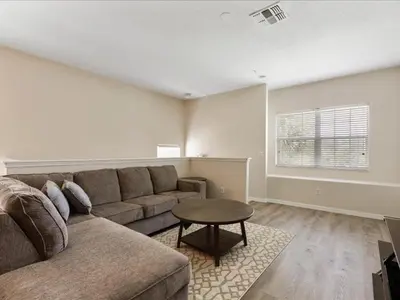 a living room with a couch and a table at Oakwater Retreat condo in Orlando