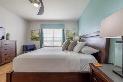 a bedroom with a large bed and a window at Your Vista Cay Lakeview Allure condo in Orlando