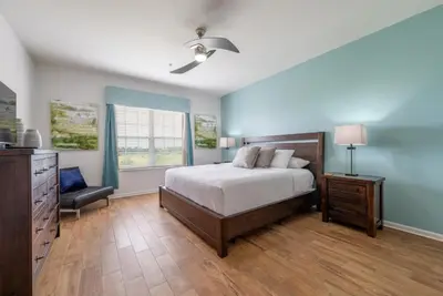 a bedroom with a bed and a dresser and a window at Your Vista Cay Lakeview Allure condo in Orlando