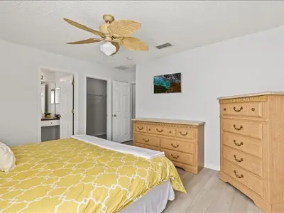 a bedroom with a bed and a ceiling fan at Treasure Hunt Retreat home in Kissimmee
