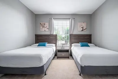 a bedroom with two beds and a window at Vista Cay Luxury Rhapsody condo in Orlando