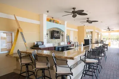 a bar in a restaurant with a bunch of chairs at Vista Cay Luxury Rhapsody condo in Orlando