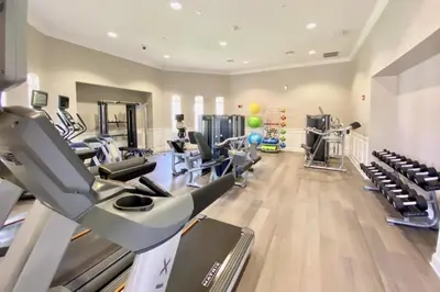 a gym with treadmills and elliptical machines at Vista Cay Luxury Rhapsody condo in Orlando