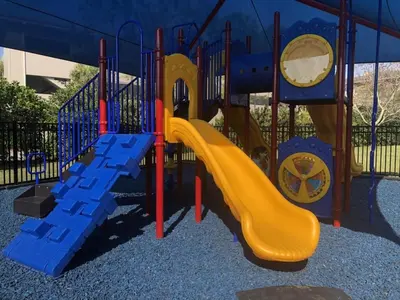 a playground with a slide in a park at Vista Cay Luxury Rhapsody condo in Orlando