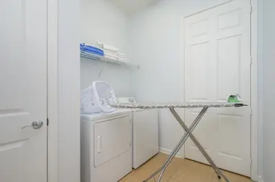 a laundry room with a drying rack next to a washing machine at Stunning Vacation Condo - Vista Cay Resort - 2016 in Orlando