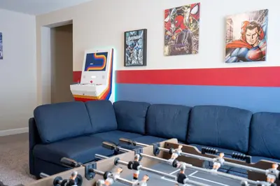 a living room with a blue couch and a table with legos at Storey Lake Pool Home with Resort Amenities near DISNEY in Kissimmee