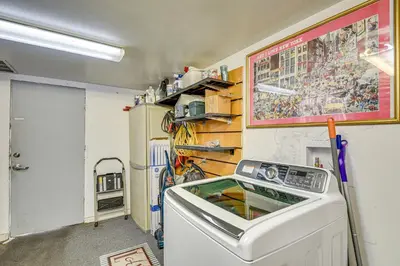 a laundry room with a washing machine and a wall at Walk to Historic Dtwn Sanford Home with Gas Grill! in Sanford