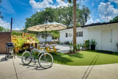 a bike parked in a yard with an umbrella at Walk to Historic Dtwn Sanford Home with Gas Grill! in Sanford