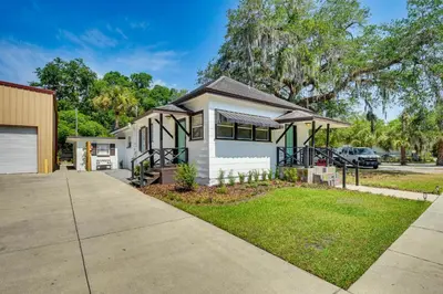 a small white house with a driveway at Walk to Historic Dtwn Sanford Home with Gas Grill! in Sanford